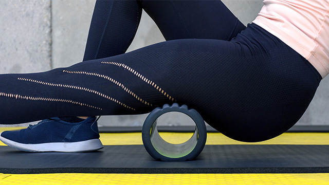 Here’s Your Guide For When, Why, And How To Use A Foam Roller Woman Using A Foam Roll After A Workout