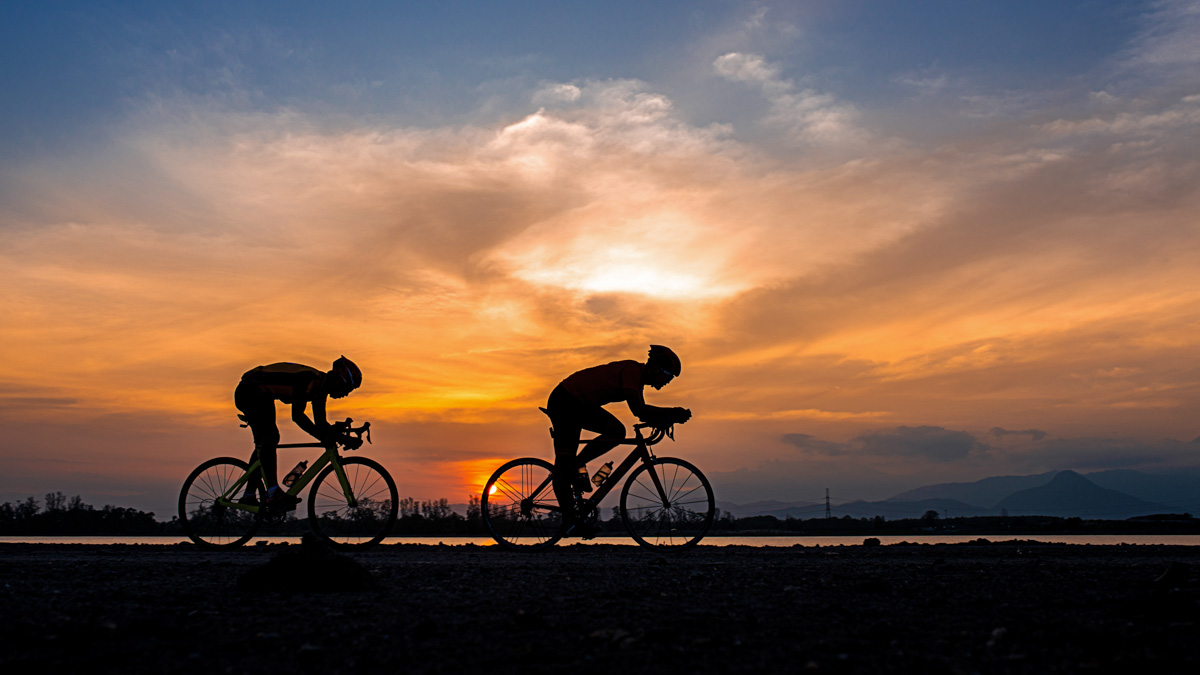 Silhouette Two Road Bike Cyclist Man Cycling In The Morning. Silhouette Two Road Bike Cyclist Man Cycling In The Morning.