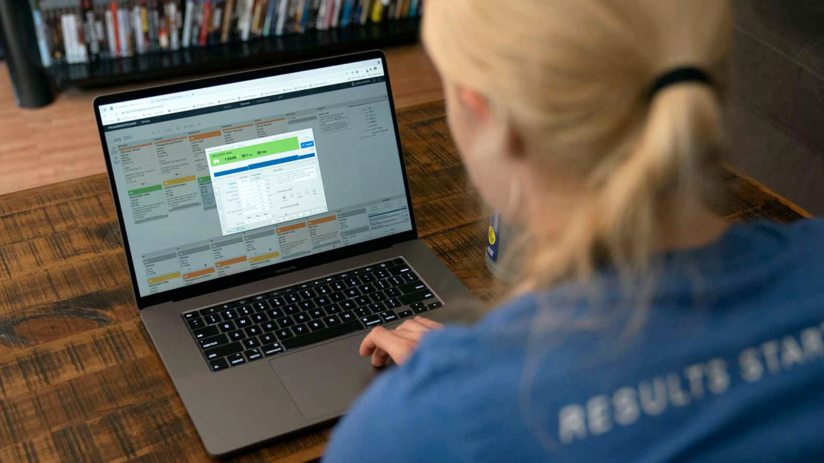 A Coach Using Trainingpeaks Free 7 Day Trial A Coach Using Trainingpeaks On Her Laptop In Her Home Office