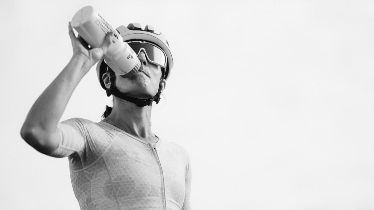 Female Triathlete Drinking Water In Black And White Image